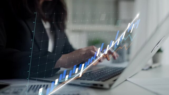 A focused business professional interacts with a laptop displaying dynamic graph analytics, symbolizing financial growth and strategic planning in a modern office setting. Copula