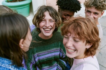 Fototapeta premium Group of diverse young friends laughing and chatting on a city street, wearing cozy knit sweaters in a joyful community and youth lifestyle moment