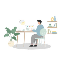 Fototapeta premium A man sits at a minimalist wooden desk working on his laptop in a cozy home office filled with plants, books, and soft natural lighting.
