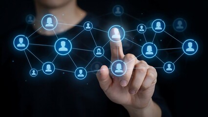 Obraz premium A hand touching a glowing network of connected people icons, symbolizing connections and networking