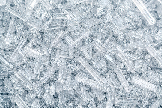 Macro of citric acid crystals, transparent food additive texture background
