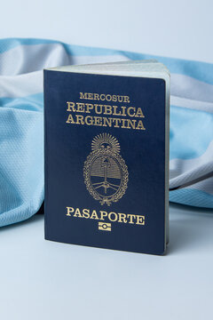 Argentine passport in a light blue and white background. Argentine flag. Citizenship, travel, and immigration