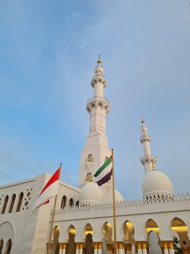 SURAKARTA, INDONESIA &ndash; MAY 5, 2024: Indonesian and United Arab Emirates flags stand before the minarets and domes of Sheikh Zayed Grand Mosque in Solo.