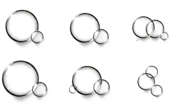 Multiple clear transparent water bubbles arranged in unique groups isolated on a clean white background for creative design projects