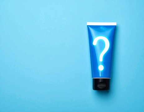 Question mark from toothpaste. Concept of choosing good toothpaste for teeth whitening. Tube of colored toothpaste on blue background. Copy space for text.