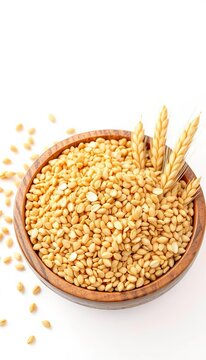 Dried wheat grains in wooden bowl on white background, brown, agriculture