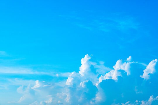 A bright, clear blue sky meets a glowing white horizon, suggesting a serene, open, and with sunlight of beautiful cloudy sky. landscape or abstract background	