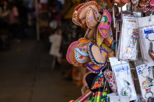 Colorful Leather Pouches And Souvenir Keychains Displayed At Mexican Market Stall