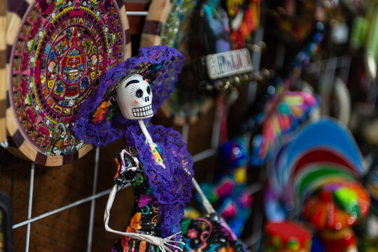 Mexican Catrina Skull Doll in Purple Lace Displayed at Traditional Artisan Market