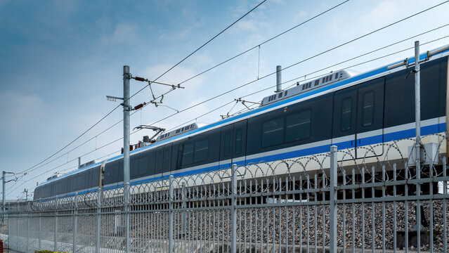 Modern electric passenger train on elevated railway tracks