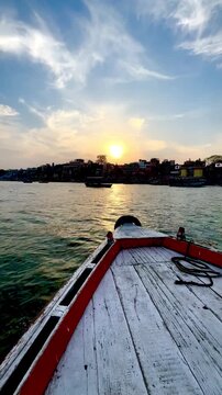 SAILING IN A WOODEN BOAT ON THE SACRED GANGES RIVER IN INDIA
