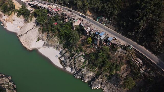 Drone shot around homes on the side of the Prithvi highway, sunny day in Nepal