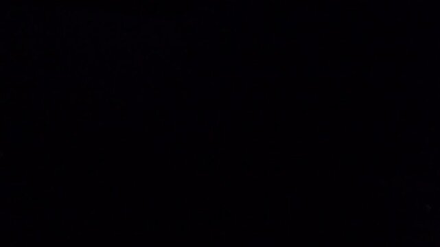 View from African lodge of lightning striking earth in dark nighttime