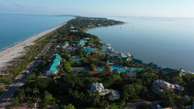 Drone shot of the iconic Tween Waters Inn on Captiva Beach, where the island's slender shape puts the resort between calm bay marinas and open Gulf shoreline.