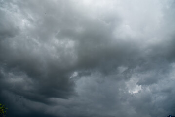 Obraz premium Dark gray sky cloudy environment. Meteorology danger windstorm disasters climate. Dramatic dark storm rain clouds black sky background. Dark cloudscape storm disaster gloomy gray cloud sky. Nimbus