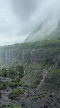 4K view of monsoon clouds and multiple waterfalls in the breathtaking Sahyadri mountain range.