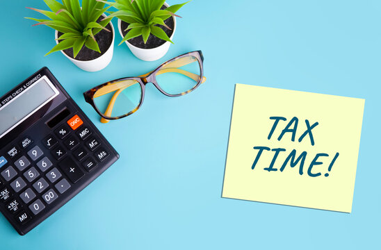 Tax Time Concept with Sticky Note, Calculator, and Glasses