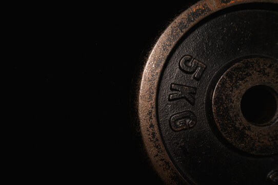 Close-up of a 5kg Textured Weight Plate: Raw Strength Grit for Your Weightlifting Journey