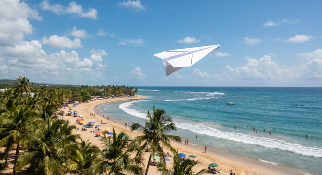 White paper airplane flying above a tropical beach and turquoise ocean under blue sky, symbolizing summer travel, freedom, tourism and adventure, with palms, copy space and tilt-shift effect.
