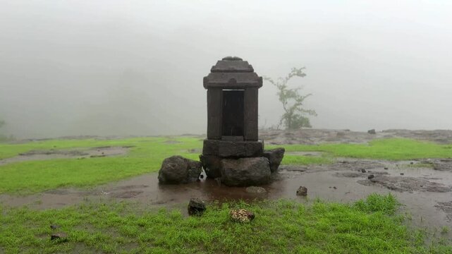 Historic remnants of the Maratha Empire on Siddhagad Fort, Maharashtra, amidst the Sahyadri mountains.