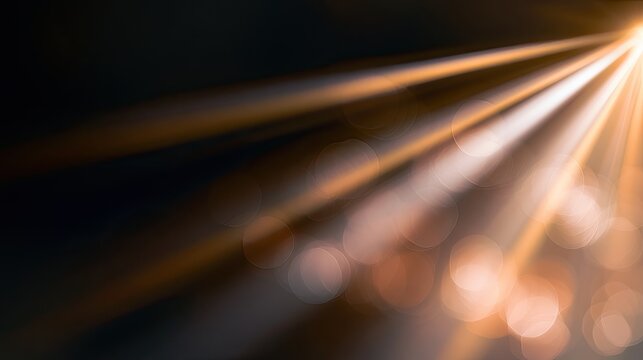 Golden Light Rays Shining Through Darkness with Bokeh Effect.