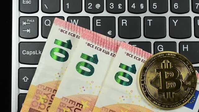 Bit Coins and Euro money on computer Keyboard