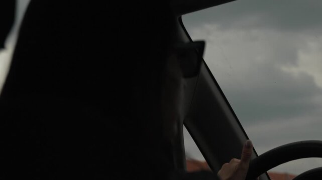 Cinematic Driving Travel Woman holding steering wheel under dark sky Vertical video.