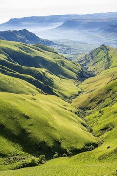 Green meadows and mountain valley, cathedral range mountain landscape, Drakensberg Mountains, KwaZulu-Natal, South Africa