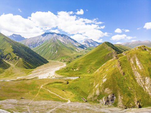 Panoramic views of green caucasus mountains and old tower ruins of ancient towers. Georgia and Russia boder mountains pass in Truso valley. Georgia
