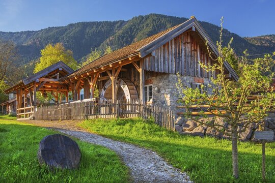 Historic Schleifm&uuml;hle, water mill, in the village in spring, Ohlstadt, Loisach Valley, The Blue Land, Upper Bavaria, Bavaria, Germany