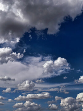 Dark Storm Clouds Gathering Over Deep Blue Summer Sky