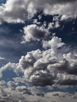 Large Dark Cumulus Clouds Covering Deep Blue Sky