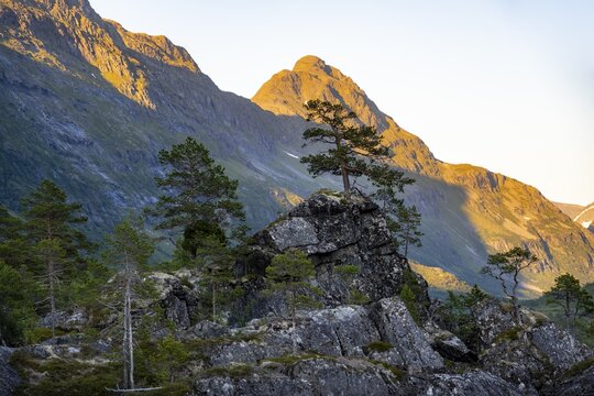 Picturesque mountain landscape in the Innerdalen high valley, silhouettes in front of mountain peaks, reflection in Lake Innerdalsvatna, Trollheimen Mountain Area, Sunndal, M&oslash;re og Romsdal, Norway