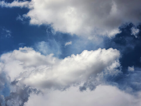 Bright White Clouds Drifting Across Deep Blue Summer Sky