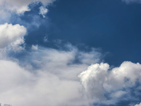 Soft White Cumulus Clouds Framing Clear Blue Sky