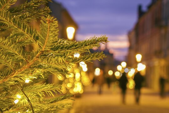Blurred zoom out background city street with Christmas illuminations, blurred holiday background. Christmas lights and Christmas decorations on the street. Banner, designs. copy space.Xmas new year