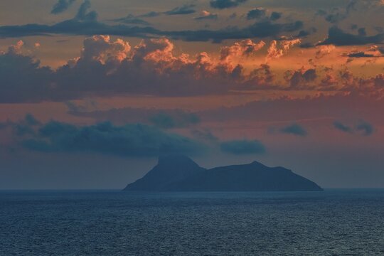 Paximadia island, colorful sunset over an island in the sea with dramatic cloud landscape, Matala, south coast, Crete, Greek Islands, Greece