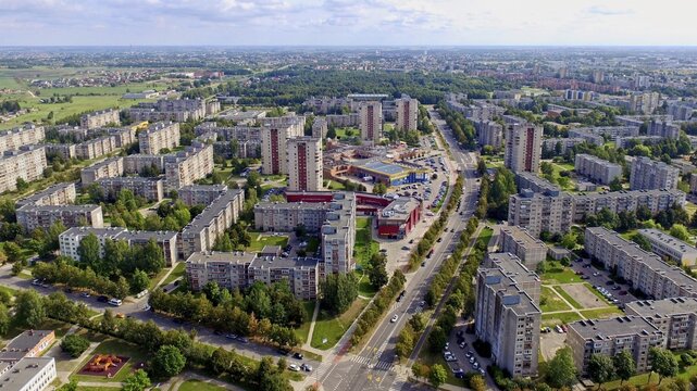 Aerial view of a sprawling urban residential area with multiple soviet buildings and greenery, Siauliai. Lithuania