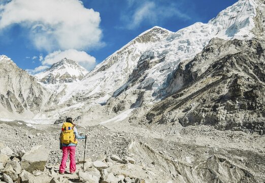 Woman trekker alone stands by EBC viewpoint in Sagarmatha national park with mountains background. EBC trekking. Everest base camp trekking. Khumbu icefall panorama