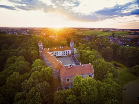 Historical Panemune castle in dramatic sunset conditions with green nature and sunset flare. Birstonas. Lithuania