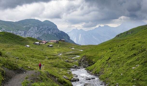 Hikers on a hiking trail at Bergbach Sousbach, Oberberg Almen, Bernese Alps, Bernese Oberland, Switzerland