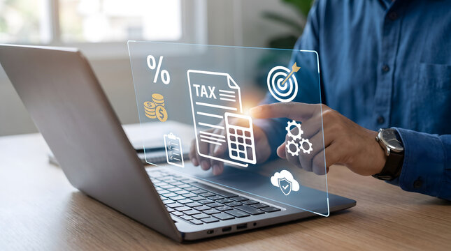 Businessman using laptop with digital tax document hologram and calculator, online e-filing, Financial accounting and virtual tax preparation concept,