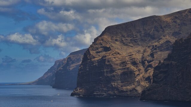 Los Gigantes, Calm sea and dramatic rocks under a cloudy sky in natural surroundings, Masca, Barranco de Masca, canyon, Teno, Teno Mountains, northwestern Tenerife, Tenerife, Canary Islands, Spain