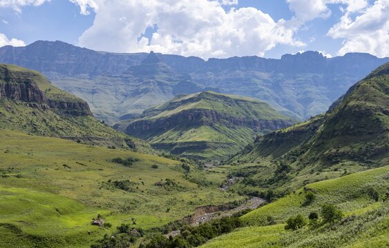 Mountainous landscape of the Cathedral Range mountains and green mountain valley, Drakensberg Mountains, KwaZulu-Natal, South Africa