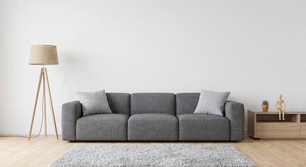 Minimalist living room interior featuring modern grey sofa and wooden tripod floor lamp decor with small wooden console table against plain white wall © Sanoor