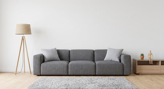 Minimalist living room interior featuring modern grey sofa and wooden tripod floor lamp decor with small wooden console table against plain white wall