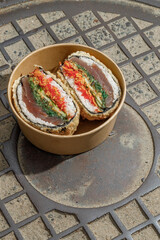 Sushi burger on a metal wire rack. Delivery box. Art photo © Cavan