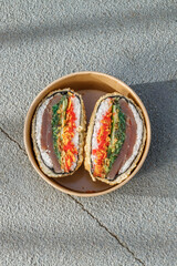 Sushi burger on road markings. Delivery box. Art photo. © Cavan