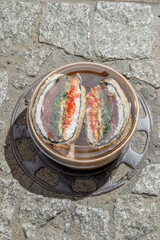Sushi burger on a metal wire rack. Delivery box. Art photo © Cavan
