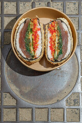 Sushi burger on a metal wire rack. Delivery box. Art photo © Cavan